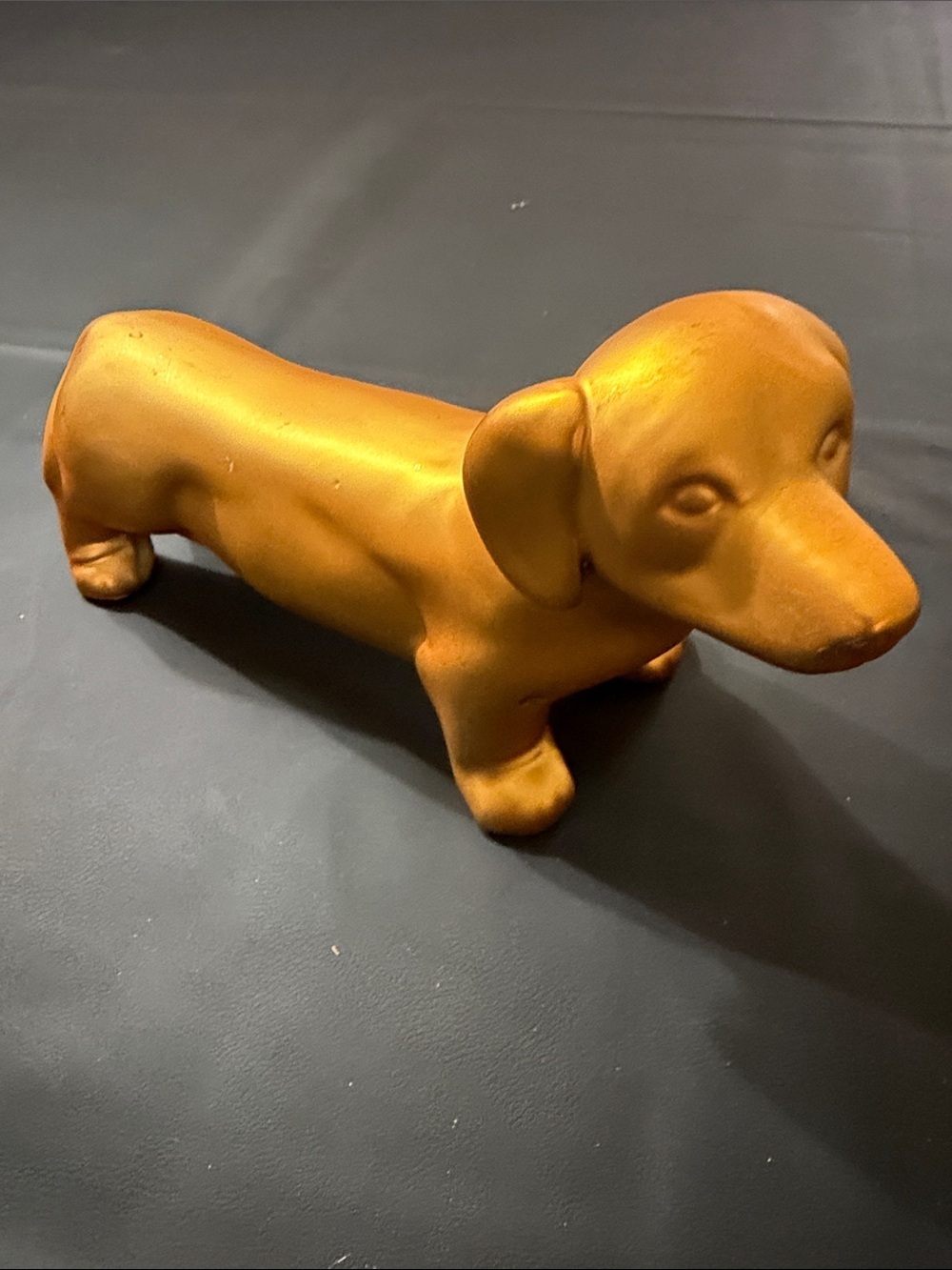 Isaac Jacob’s gold Dachshund Dog figurine.